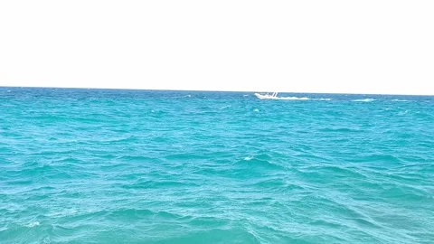 A boat at sea, leaving a wake behind on a sunny, clear day. An active lifestyle  Stock Footage 334223418