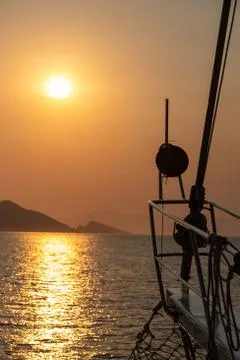 Boat at sea while sun sets Stock Photos