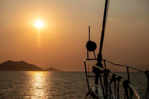 Boat at sea while sun sets Stock Photos