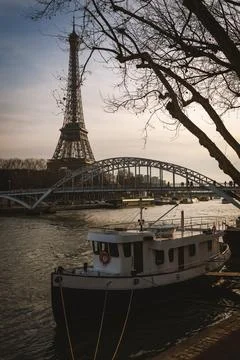 Boat on the Seine River in Paris. Eiffel Tower in the background Stock Photos