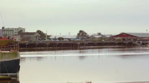 Boat ship pulls into harbor slowly overcast dock Stock Footage 45734366