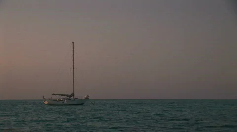 A boat off shore at sunset. Stock Footage 65490