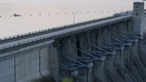 A Boat Sits By A Dam Wall Stock Footage 87397076