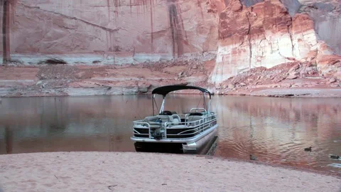 Boat sits docked on sandy beach, canyon walls HD Stock-Footage 80237958