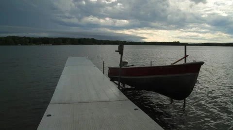 A Boat Sits next to a Dock as a Storm Approaches Stock-Footage 66435125