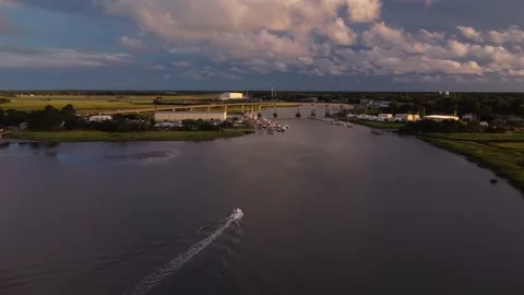 Boat Slowly Drives Down River toward Bridge During Sunset Stock Footage 201499213