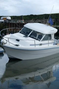Boat in small harbor Stock Photos