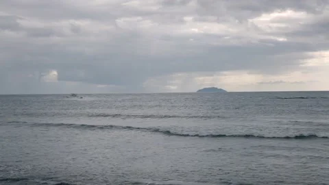 Boat speeding by beach in Rincon Puerto Rico on stormy day Stock Footage 157459538