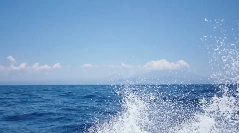 Boat splashes its way trough the beautiful Bali coastline Stock Footage 68724406