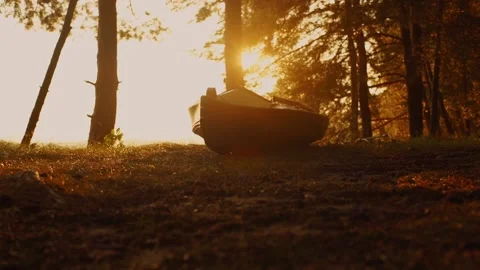 The boat stands on the shore in the rays of the sun Stock Footage 221202242