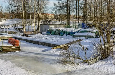 A boat station closed until spring on the banks of the Izhora River in Kolpin Stock Photos
