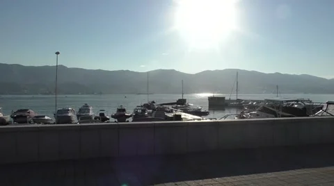 Boat Station, Sun Shining in Centre of Camera, Mountains Are on Background Stock Footage 65277587