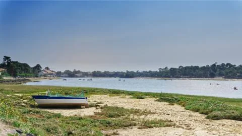 Boat stranded on the sand in front of Hossegor lake Stock Photos