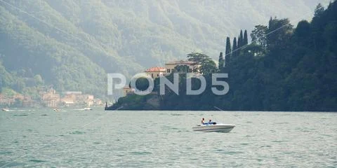 Boat on a summer day on Lake Como, Italy. Stock Photos