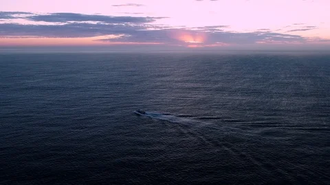 Boat at sunrise on ocean Stock Footage 107043840