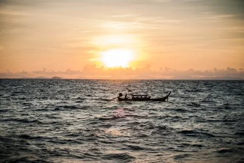 Boat in sunset close to Ko Phi Phi. Stock Photos