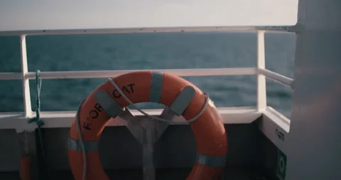 Boat swim ring life ring orange ocean slowmotion sun vacation travel 4k Stock Footage 153490751