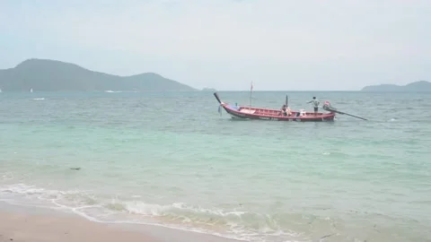 Boat swims up to the beach Stock Footage 86443524