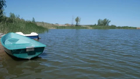 The boat is swinging on the small waves of a small pond. Stock Footage 116082939