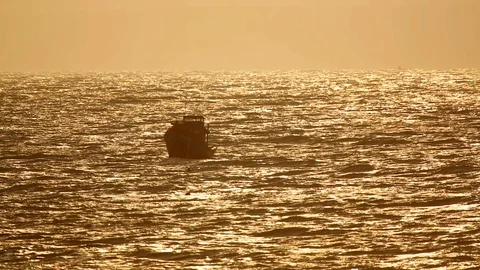 Boat swinging in the waves at sunset Stock Footage 115126024