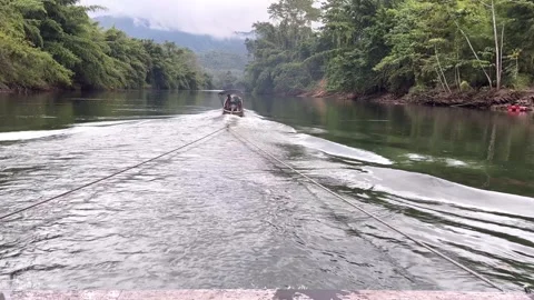 A boat is towing a raft2 Stock Footage 323242509