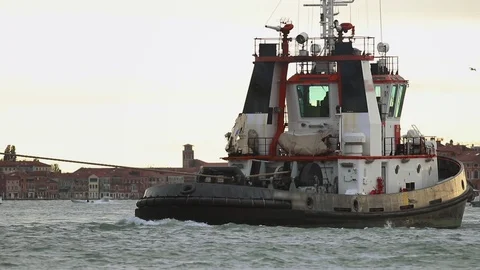 Boat tractor with a cable released floats on the river of Venice Stock Footage 112557178
