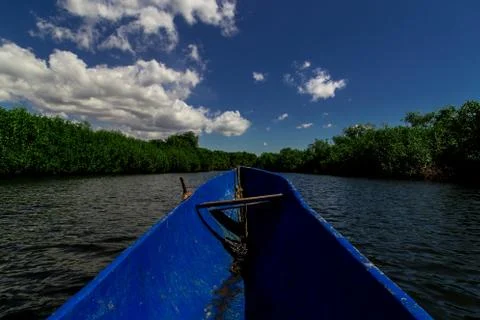Boat in tropical river Stock Photos