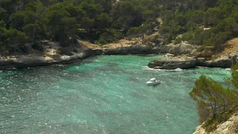 Boat in a typical cala of Menorca in a windy day, Minorca, Balearic Islands Stock Footage 303752708