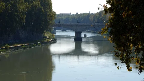 BOAT UNDER BRIDGE ON THE ARNO RIVER IN ROME Stock Footage 97520674