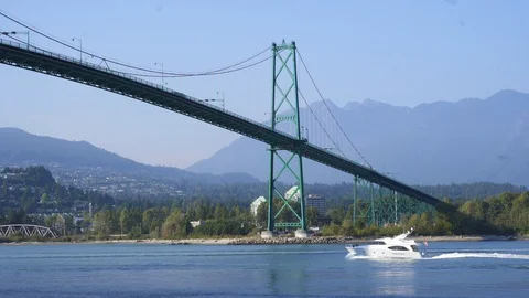 Boat under bridge lions gate 4k Stock Footage 99647523