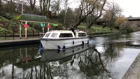 Boat using canal in London Stock Footage 136969131