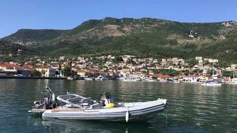 A boat with Vathy or Ithaki in the background, in Ithaca island in Greece, Stock-Footage 79856450
