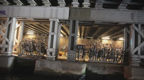 Boat view of bicycles under a bridge on canalside in Amsterdam, Netherlands Stock Footage 38568254
