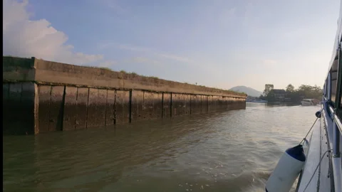A boat view of a man-made wall along the water Stock Footage 310787899