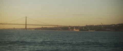 A boat view of an ocean bridge and a city port at sunset. Stock Footage 147566612