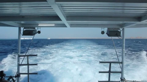 Boat wake in blue sea viewed from rear deck Stock Footage 70172016