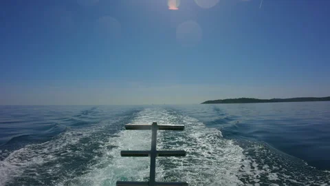 Boat Wake on Calm Blue Ocean with Distant Island, Sunny Day, Travel &amp; Leisure 動画素材 334499430