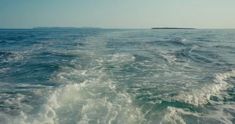 Boat Wake Churning Foam on Blue Water in Slow Motion Stock Footage 343615973
