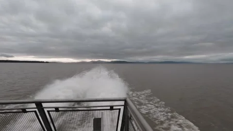 Boat wake cuts through the gray waters of the San Francisco Bay Stock Footage 328130216