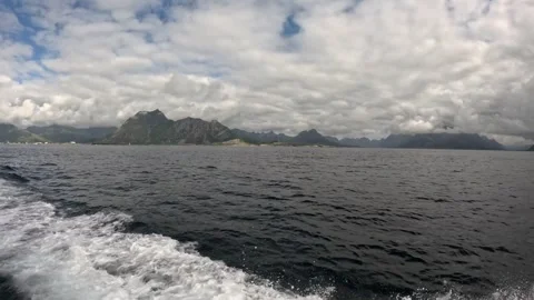 Boat wake in ocean water with mountain panorama leaving Svolvaer Lofoten Vidéo 344047345