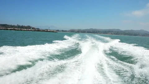 Boat Wake on Sunny Day with Harbor Coastline and Blue Sky | Handheld Ocean .. Video stock 341446953