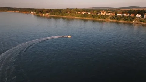 A boat is on the water with a jet ski trailing it Stock Footage 297949880