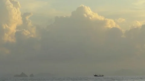 The boat is on the water, large clouds float across the sky Stock Footage 72090622