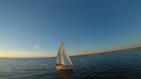 Boat on water over sunset, sailing, drone footage, close proximity Stock Footage
