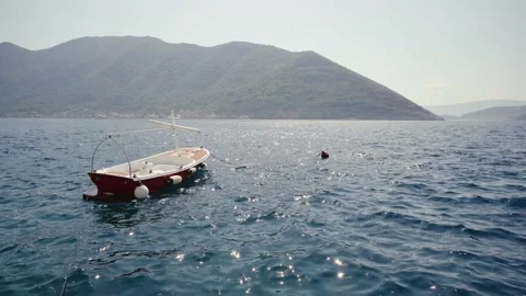 Boat on the waves against the backdrop of Mount Montenegro Stock Footage 160991507