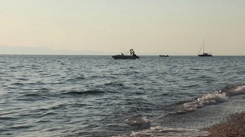 Boat on waves in the light of sunrise Stock Footage 129090393
