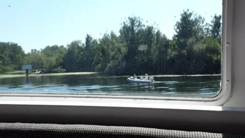 Boat window view of another passing boat Stock Footage 249635842