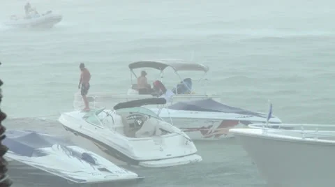 Boaters in Rainstorm Stock Footage 25189921