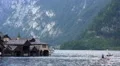 Boathouses on Hallstatt alps mountain lake in Austria HD Footage