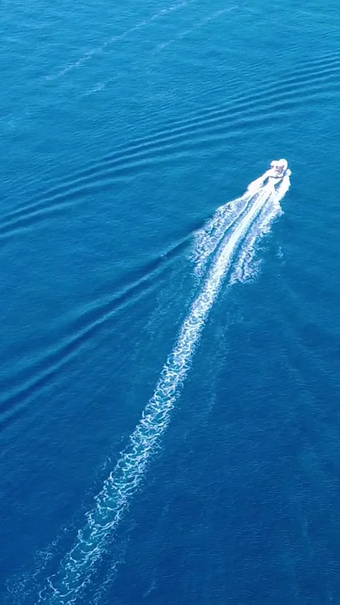 Boating Across the Clear Blue Waters on a Sunny Day in a Coastal Location Stock Footage 311111530